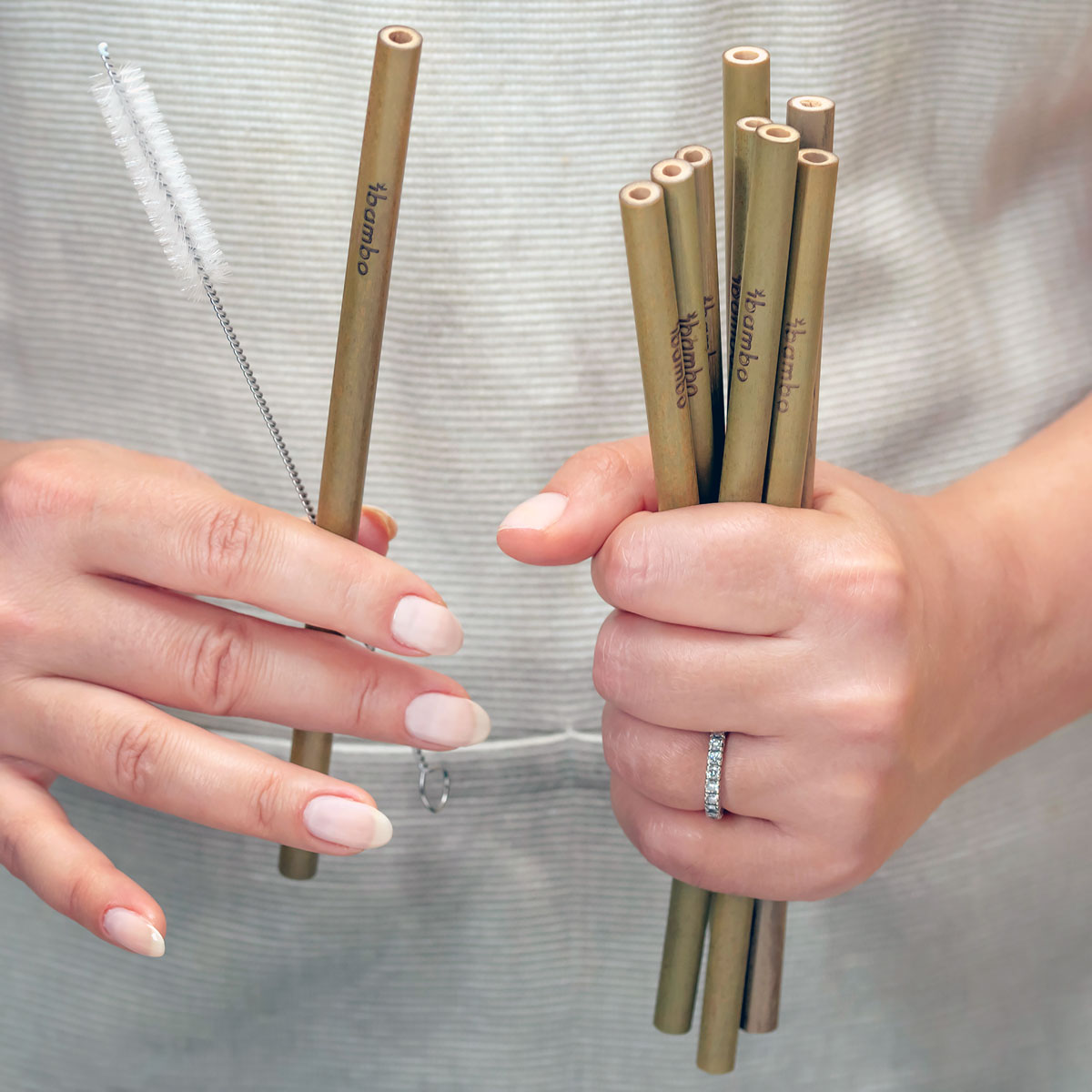 woman holding bamboo straws