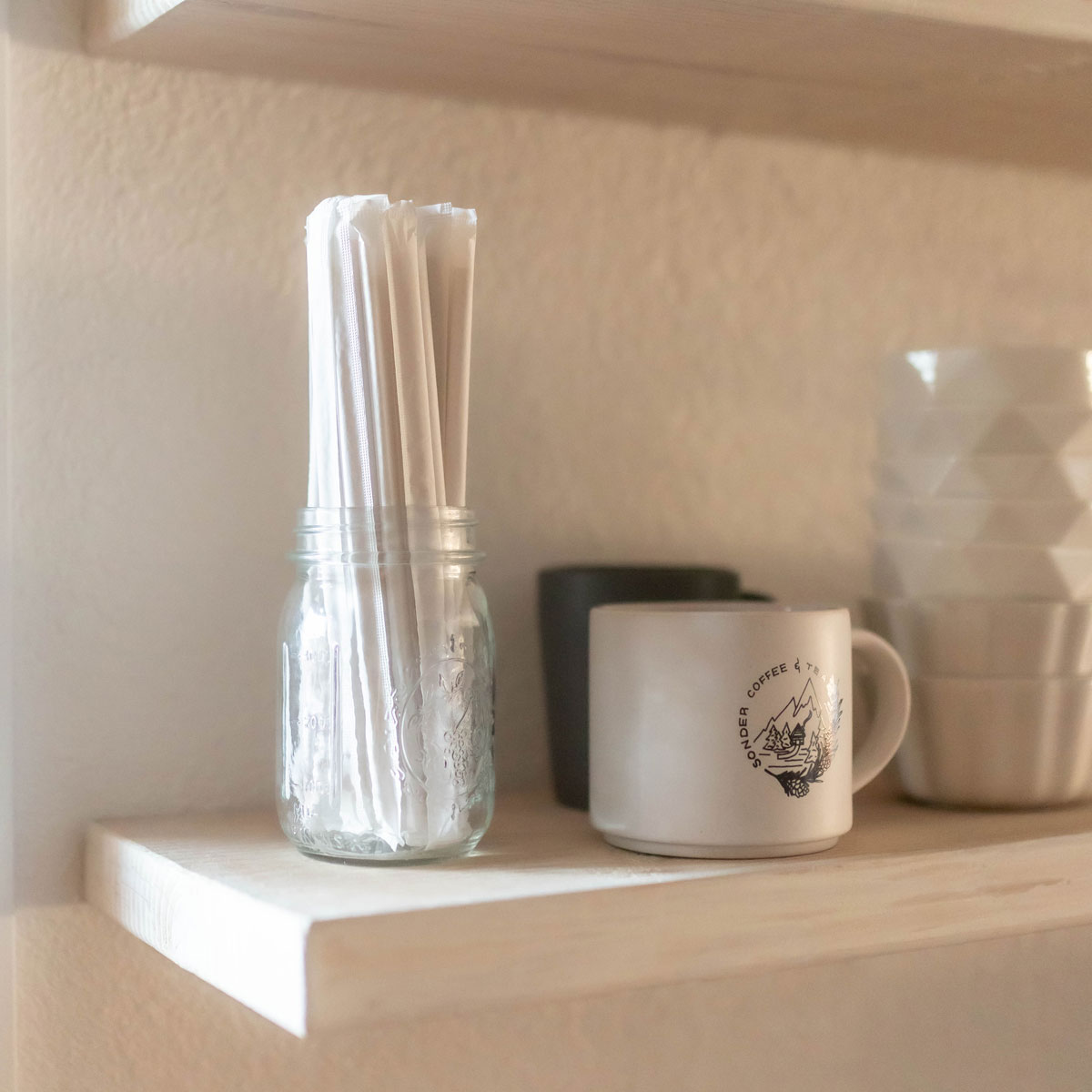 Individually wrapped bamboo straws stored in a glass jar
