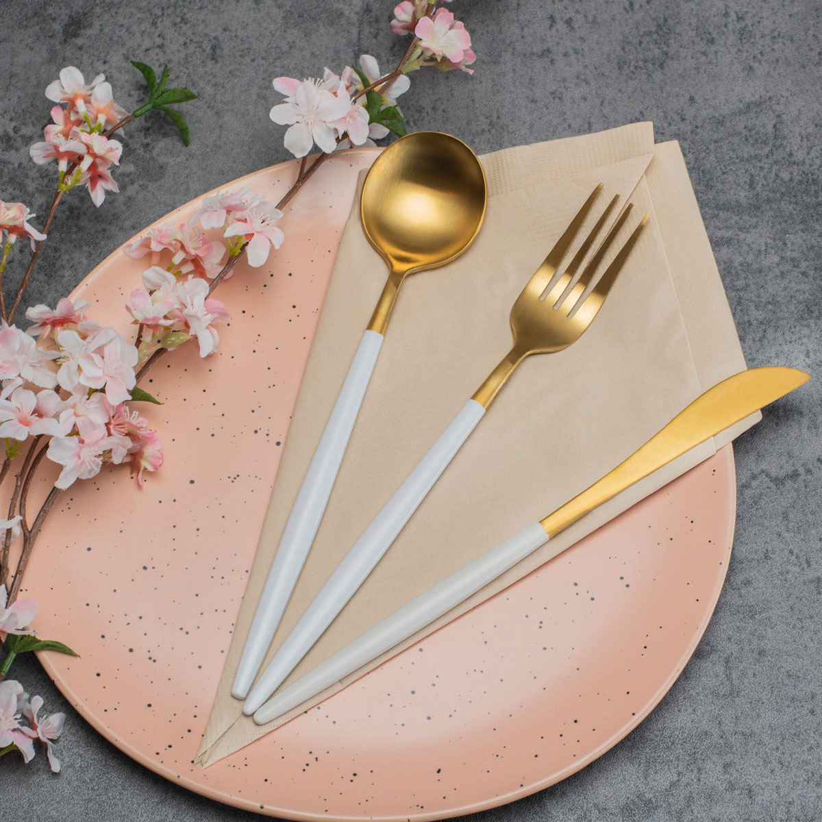 Bamboo napkin with reusable fork, knife and spoon on a table setting