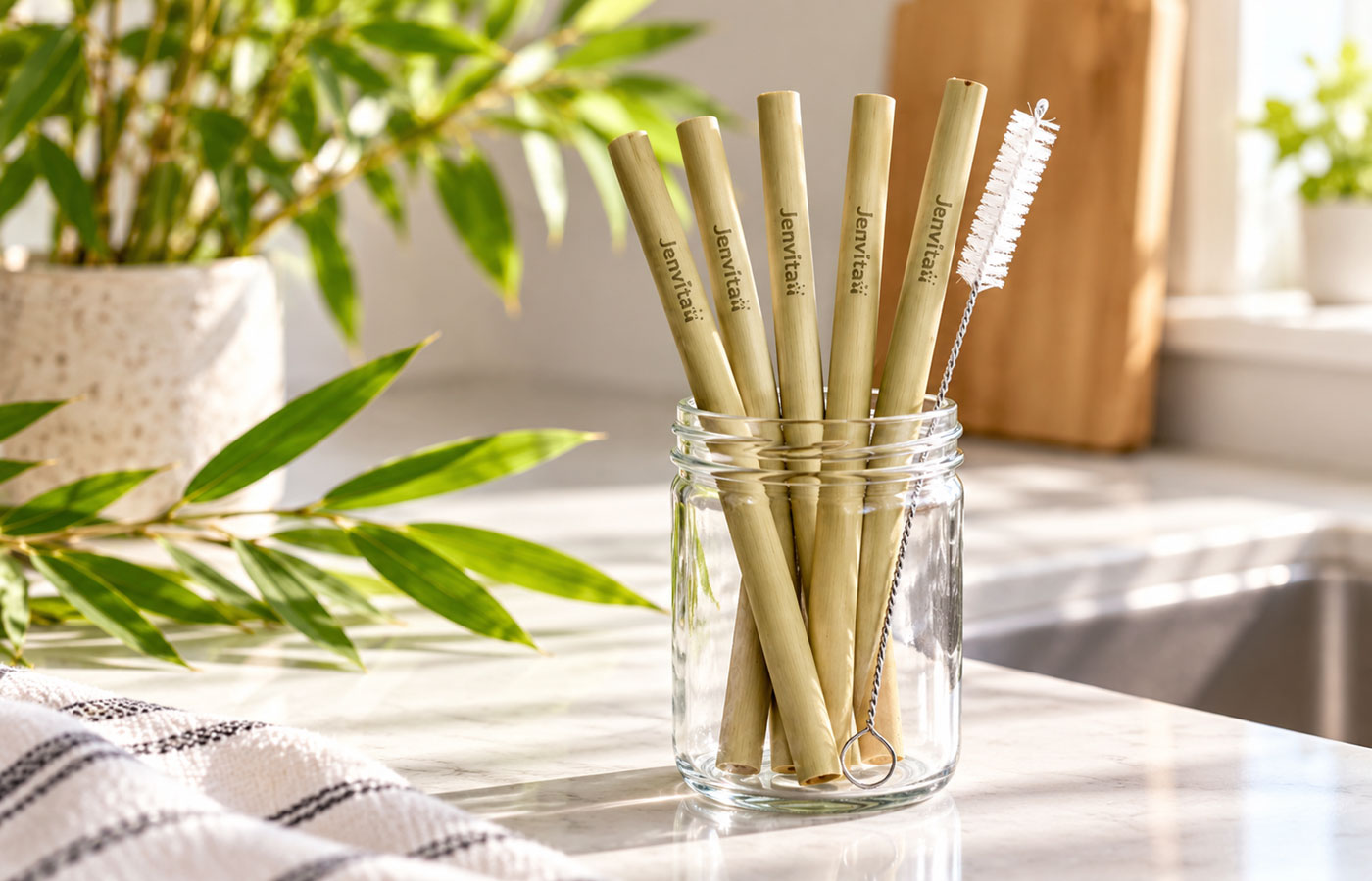 reusable bamboo straws in a glass jar in the kitchen